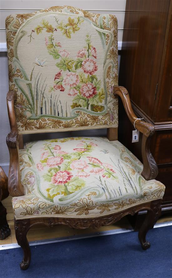 A pair of Louis XV style walnut open armchairs